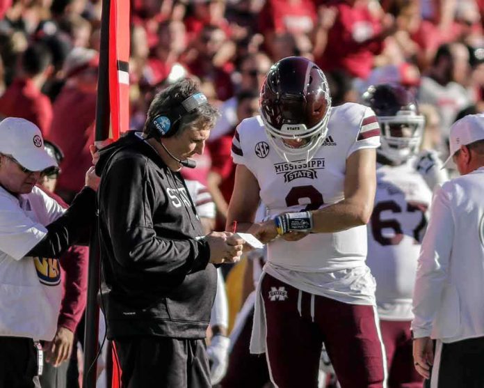 football coach and quarterback confer on sideline