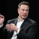 man in a suit speaking with hand gestures