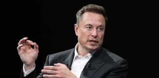 man in a suit speaking with hand gestures
