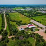 Aerial view of rural landscape with roads, fields, and scattered buildings