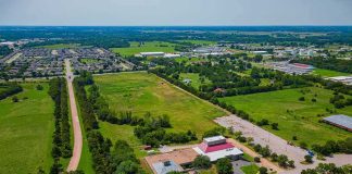 Aerial view of rural landscape with roads, fields, and scattered buildings