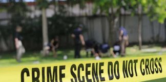 crime scene tape cordoning off a grassy area