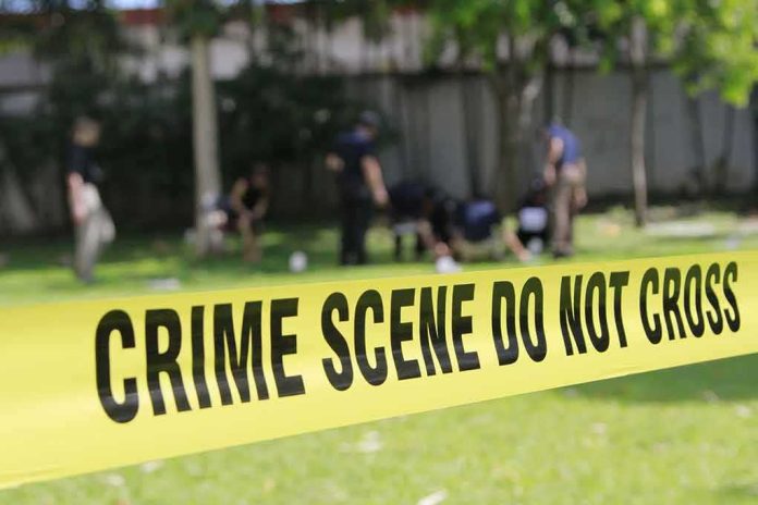 shutterstock_308657879-1 crime scene tape cordoning off a grassy area