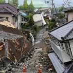 Earthquake-damaged residential street with collapsed houses