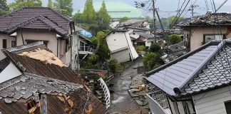 Earthquake-damaged residential street with collapsed houses