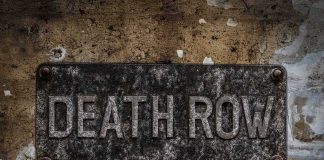 Rusty metal sign on worn concrete wall