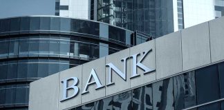 Bank building facade with large sign and glass windows