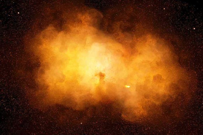 Bright orange cosmic explosion cloud in space
