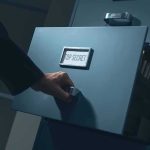 Hand opening a filing cabinet drawer labeled top secret