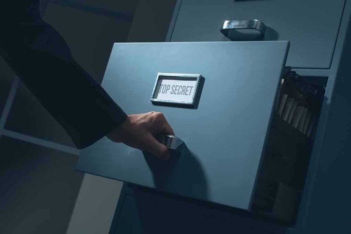 Hand opening a filing cabinet drawer labeled top secret