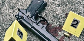 Handgun on pavement with evidence markers