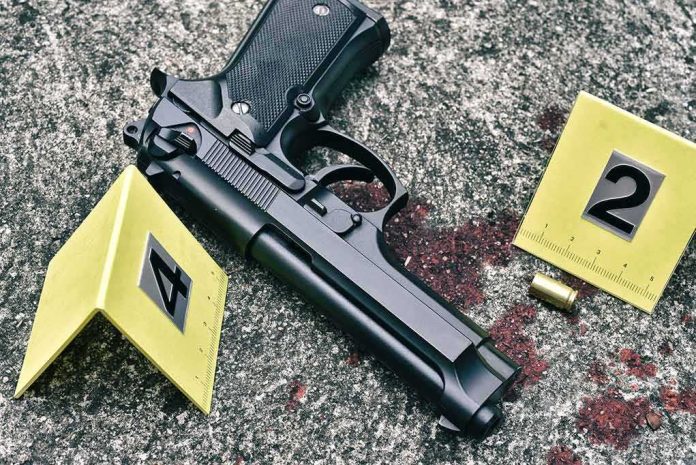Handgun on pavement with evidence markers