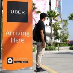 Man waiting at Uber pickup zone