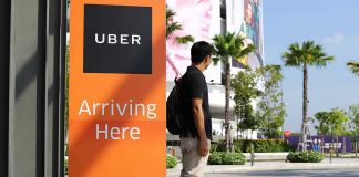 Man waiting at Uber pickup zone
