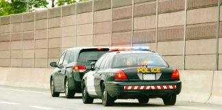 Squad Dem Pinned A Death On Agents — Look Where They REALLY Were Police car with flashing lights stops a minivan on highway