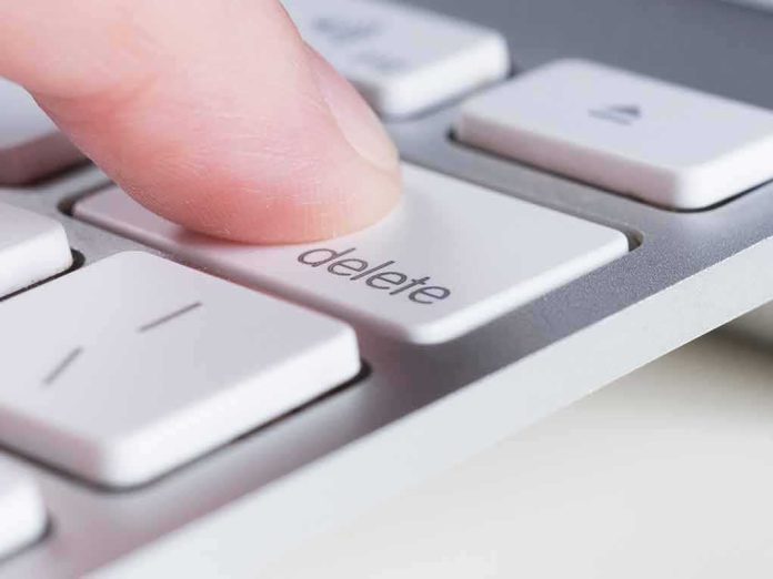 shutterstock_1007688253-1 Finger pressing delete key on a white computer keyboard