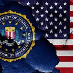 FBI seal and American flag on cracked wall