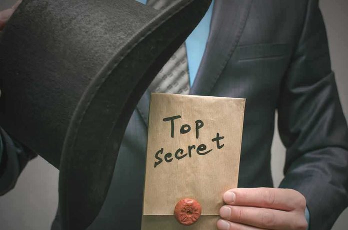 Person in suit holding a top hat and sealed envelope