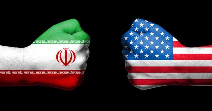 Fists painted as Iran and United States flags facing each other