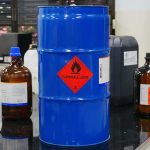 California CHEMICAL CRISIS: 50,000 URGENTLY Evacuated Blue chemical drum with flammable hazard label in a laboratory
