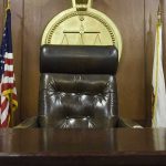 judge's chair in a wooden courtroom