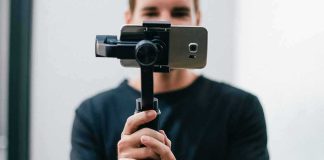 Person holding a smartphone on a handheld gimbal