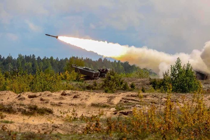 rocket artillery launcher firing in a sandy field