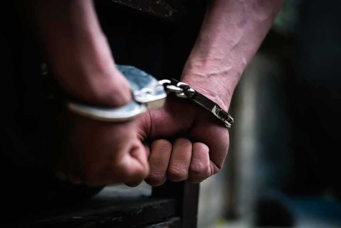 hands in handcuffs behind back