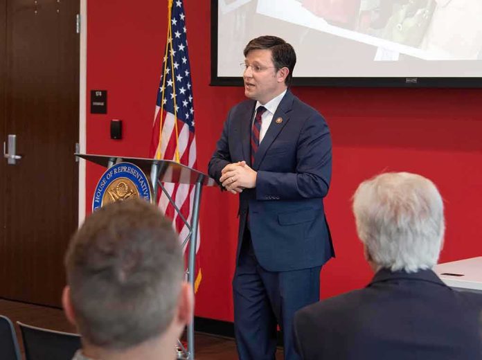 shutterstock_1381036310 Speaker in a navy suit addressing an audience at a podium