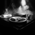 Senate Candidate Caught Hiding His REAL Agenda Reel-to-reel tape recorder in moody smoke-lit scene