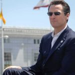Newsom Signed A Law To Stop Them — Then The Feds Sent A MESSAGE Gavin Newsom wearing sunglasses in a navy suit outdoors