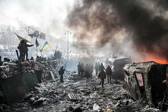 A chaotic protest scene with smoke, fire, and people holding flags