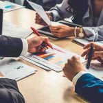 business team reviewing charts at a meeting table