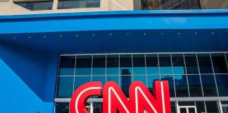 CNN logo sculpture outside a modern glass building