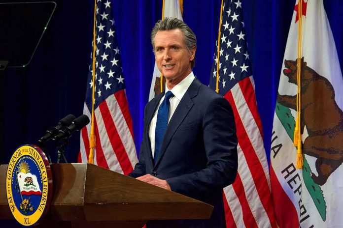 Man in suit speaking at a podium with American and California flags