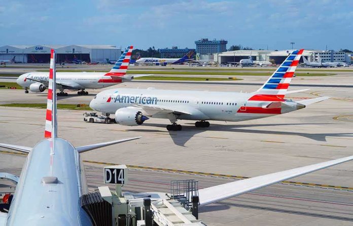 shutterstock_2152349011 American Airlines jets taxi at a busy airport apron