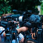 Taxpayer Outrage: Tablets Misused in Prisons TV news cameras crowding together at an outdoor event