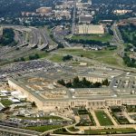 Aerial view of a large five-sided government building with surrounding highways