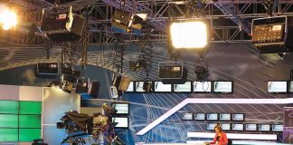 News studio with anchor at desk and cameras