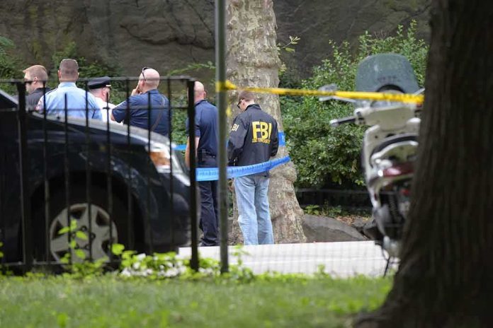 law enforcement officers gather at taped-off outdoor scene