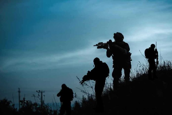Silhouetted soldiers patrolling a hillside at dusk