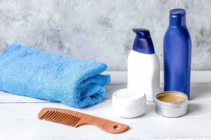 bathroom toiletries with blue towel and wooden comb on white surface
