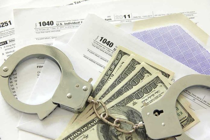 Handcuffs on tax forms with cash