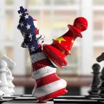 Chess pieces with US and China flag designs colliding on a board