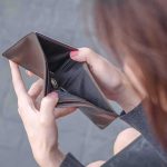 Hands holding an open empty wallet