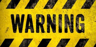 warning sign with yellow and black hazard stripes
