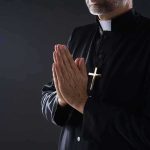Bishops BACKPEDAL On Trump Prayer — What They REALLY Came For Clergyman in black robe praying with hands together