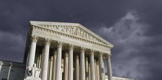 United States Supreme Court building with columns under stormy sky