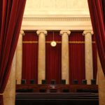 Courtroom with red curtains and marble columns