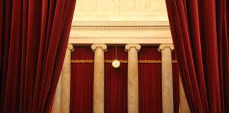 Courtroom with red curtains and marble columns